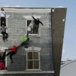 Visitors are seen by their reflections as they pose on Argentine artist Leonardo Erlich’s optical illusion installation “Dalston House” in east London